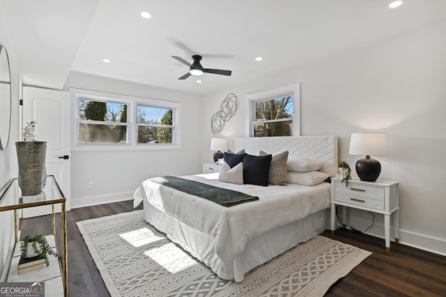 bedroom with dark hardwood / wood-style floors and ceiling fan