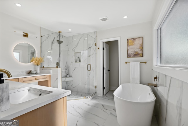 bathroom featuring plus walk in shower and vanity