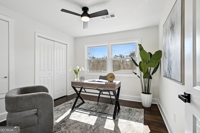 home office featuring dark wood-type flooring and ceiling fan