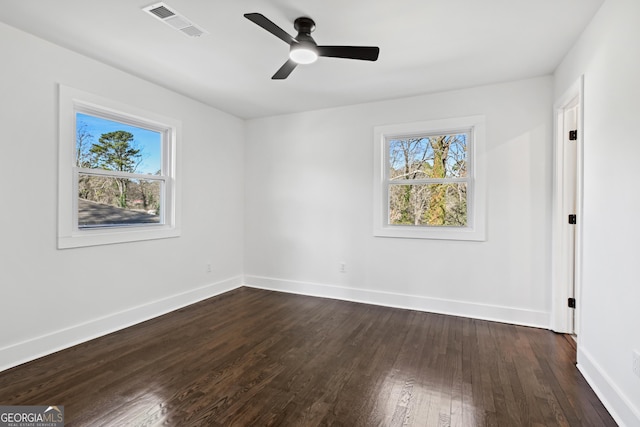 unfurnished room featuring dark wood-type flooring and ceiling fan