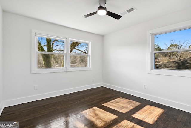 unfurnished room with dark wood-type flooring and ceiling fan