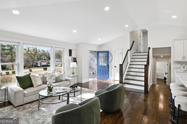 living room featuring dark hardwood / wood-style flooring and vaulted ceiling