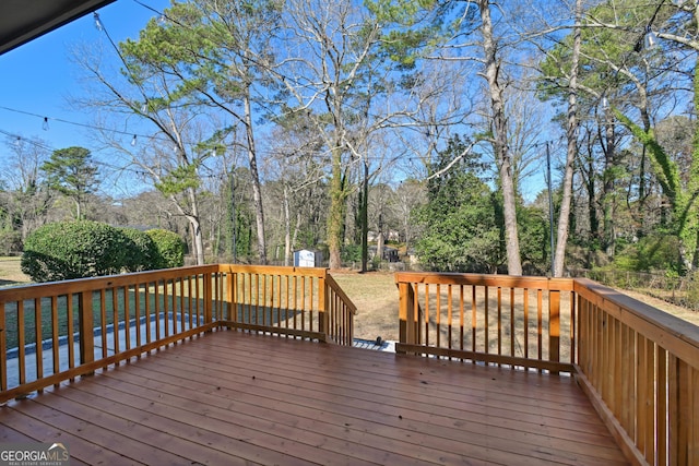 wooden terrace featuring a storage unit