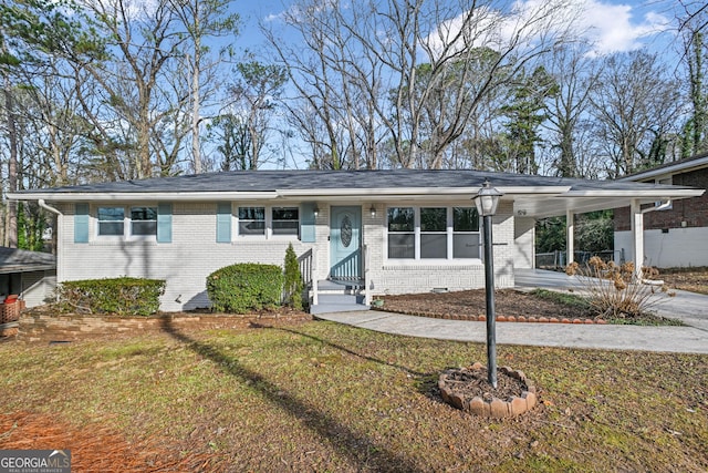 ranch-style house featuring a front yard and a carport