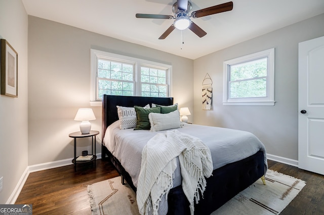 bedroom with dark hardwood / wood-style floors and ceiling fan