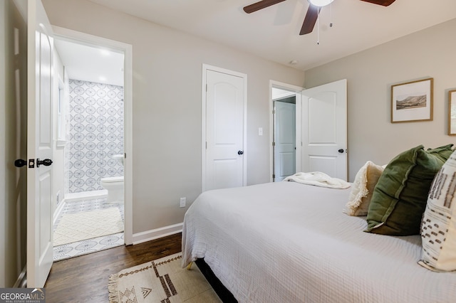 bedroom with connected bathroom, ceiling fan, and dark hardwood / wood-style flooring