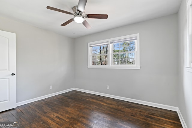 empty room with dark hardwood / wood-style flooring and ceiling fan