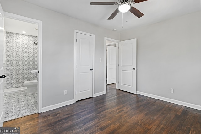 unfurnished bedroom with connected bathroom, ceiling fan, and dark hardwood / wood-style flooring