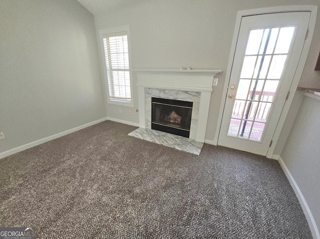 unfurnished living room with a fireplace and carpet flooring