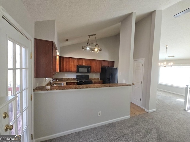 kitchen with pendant lighting, black appliances, vaulted ceiling, plenty of natural light, and light colored carpet