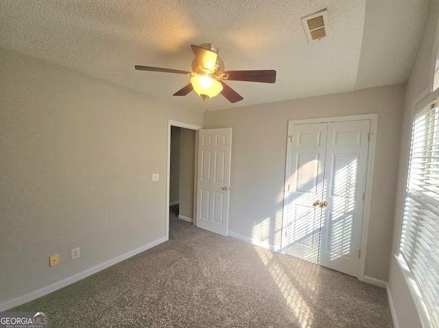 spare room with carpet flooring, ceiling fan, a textured ceiling, and vaulted ceiling