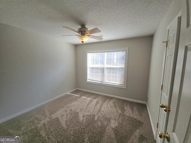 carpeted empty room featuring a textured ceiling and ceiling fan