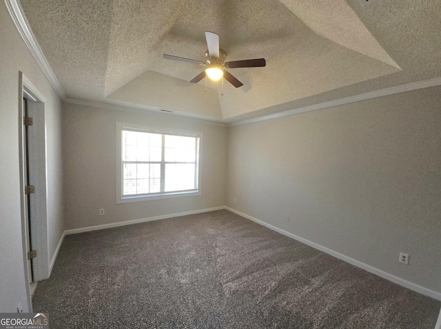 carpeted empty room with a textured ceiling, a tray ceiling, ceiling fan, and ornamental molding