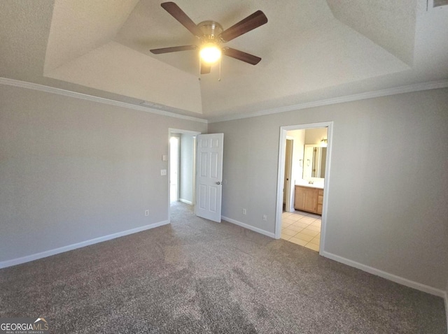 spare room featuring a raised ceiling and ornamental molding