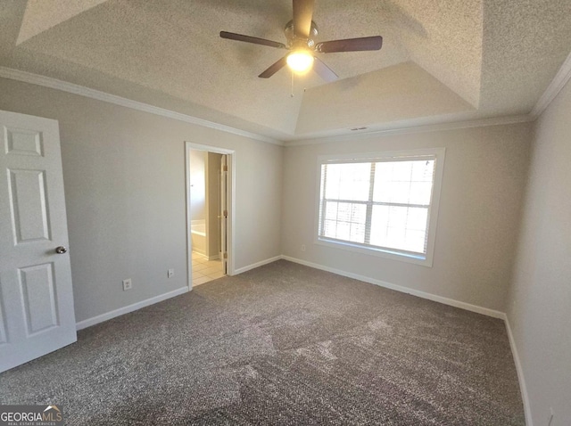 spare room featuring carpet, a tray ceiling, ceiling fan, and crown molding