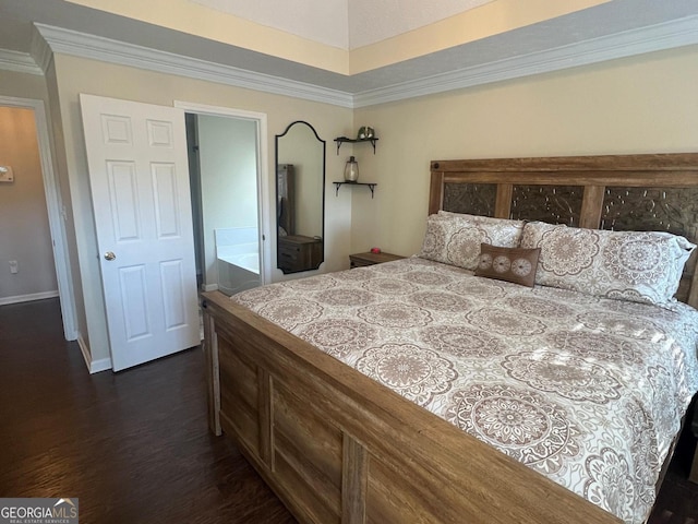 bedroom featuring ensuite bathroom, dark hardwood / wood-style flooring, and ornamental molding