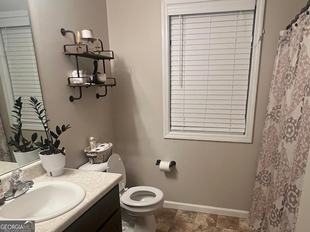 bathroom featuring vanity, a chandelier, and toilet