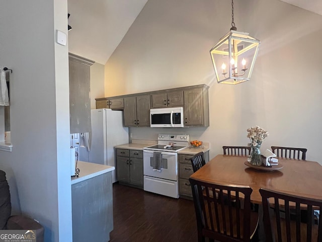 kitchen featuring gray cabinetry, dark wood-type flooring, a chandelier, pendant lighting, and white appliances