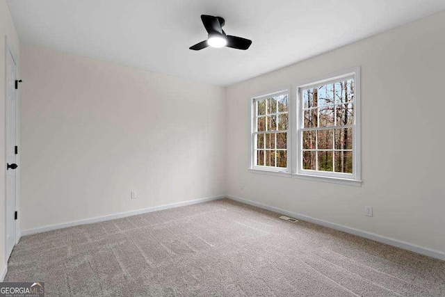 carpeted empty room with ceiling fan