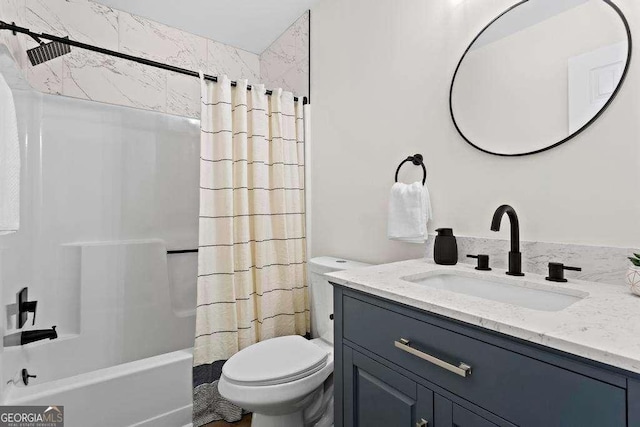 full bathroom featuring shower / bathtub combination with curtain, vanity, and toilet