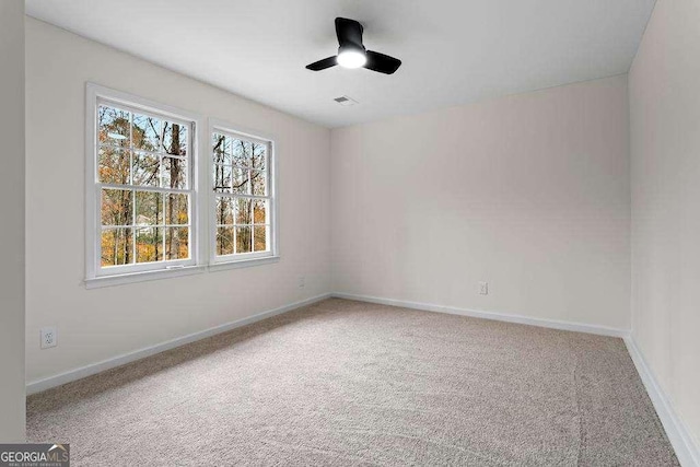 empty room with ceiling fan and carpet floors