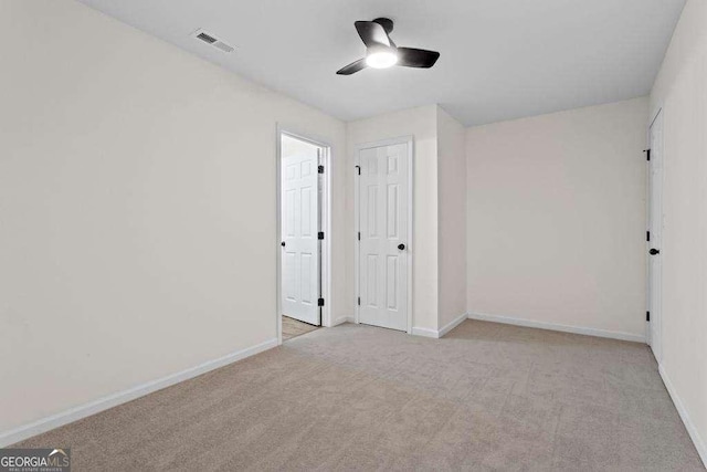 unfurnished bedroom featuring ceiling fan and light colored carpet