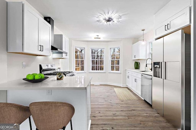 kitchen featuring pendant lighting, white cabinetry, and appliances with stainless steel finishes