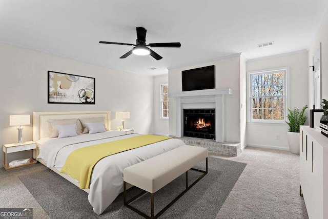 bedroom featuring carpet floors, a brick fireplace, ceiling fan, and ornamental molding