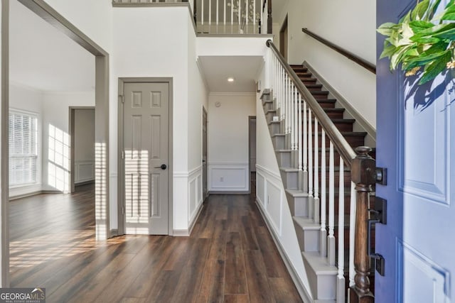 foyer with dark hardwood / wood-style floors and ornamental molding