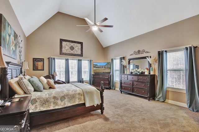 carpeted bedroom with ceiling fan, high vaulted ceiling, and multiple windows