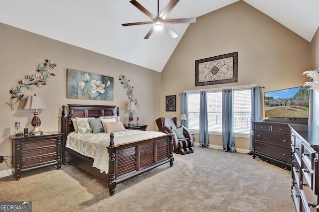 carpeted bedroom with ceiling fan and high vaulted ceiling