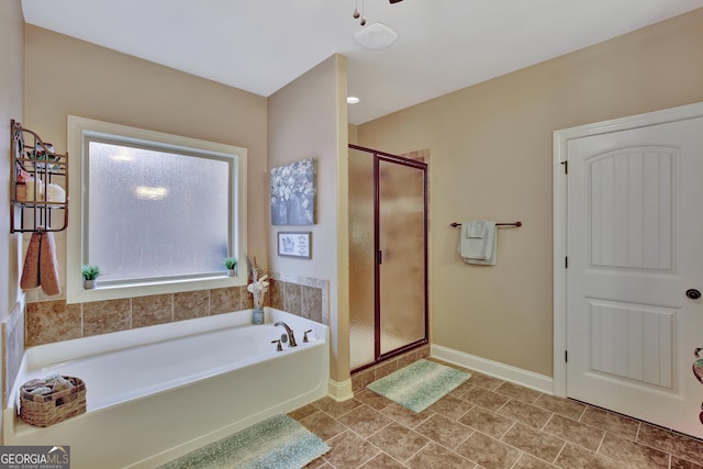 bathroom with shower with separate bathtub