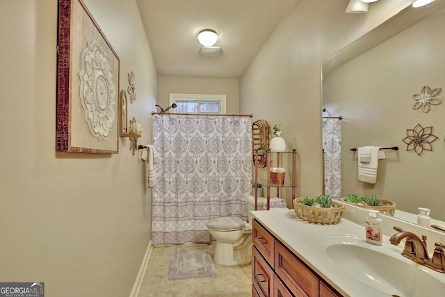 bathroom with vanity, a shower with shower curtain, and toilet