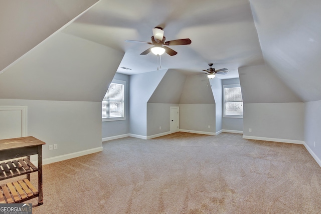 bonus room with ceiling fan, light carpet, and lofted ceiling