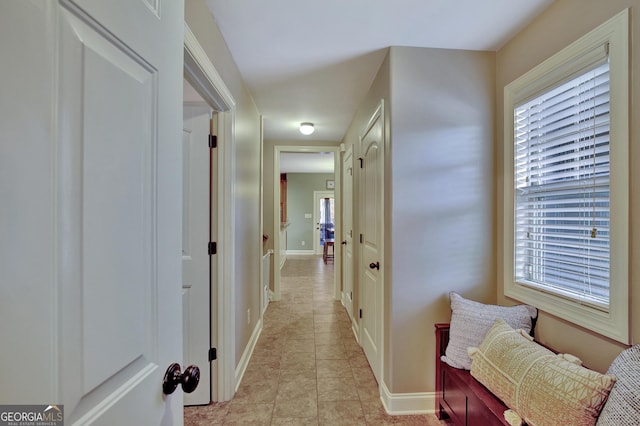 corridor with light tile patterned floors