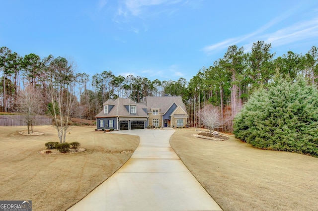 cape cod home with a front yard and a garage