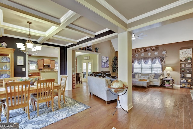 dining space featuring beamed ceiling, ceiling fan with notable chandelier, a wealth of natural light, and crown molding