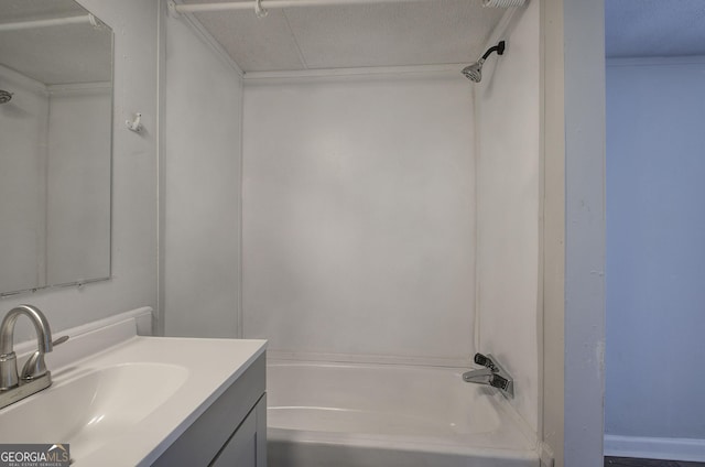 bathroom featuring shower / bathing tub combination, vanity, and a textured ceiling