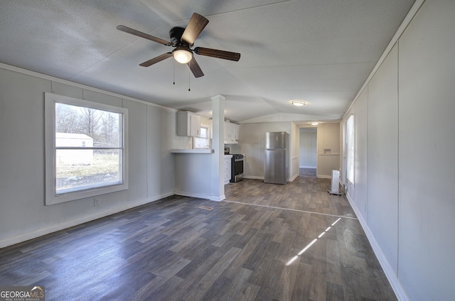 unfurnished living room with dark hardwood / wood-style flooring, vaulted ceiling, and ceiling fan