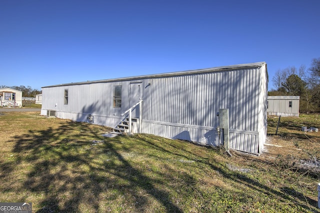 view of outbuilding with a yard