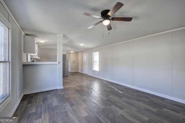 unfurnished living room with dark hardwood / wood-style floors and ceiling fan