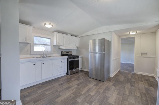 kitchen featuring white cabinetry, sink, dark wood-type flooring, lofted ceiling, and appliances with stainless steel finishes