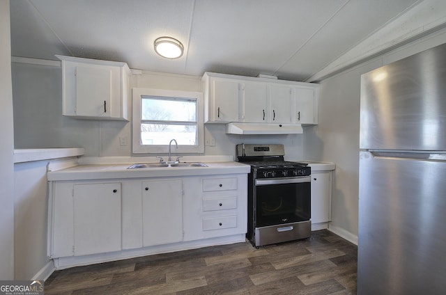 kitchen with white cabinetry, sink, appliances with stainless steel finishes, and vaulted ceiling