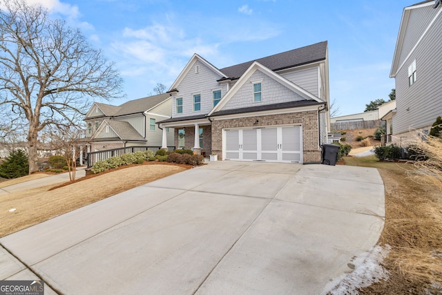 view of front of property with covered porch and a garage