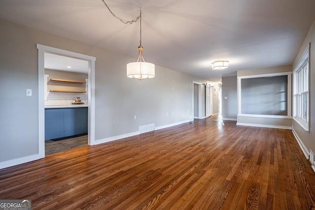 spare room with dark hardwood / wood-style floors