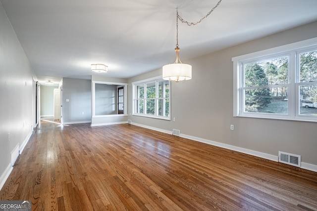 unfurnished dining area with hardwood / wood-style floors