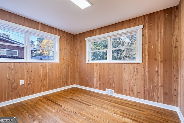 spare room with wood-type flooring