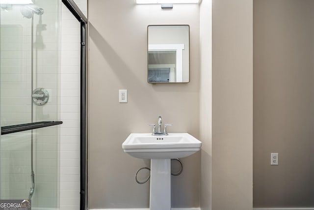 bathroom featuring sink and an enclosed shower