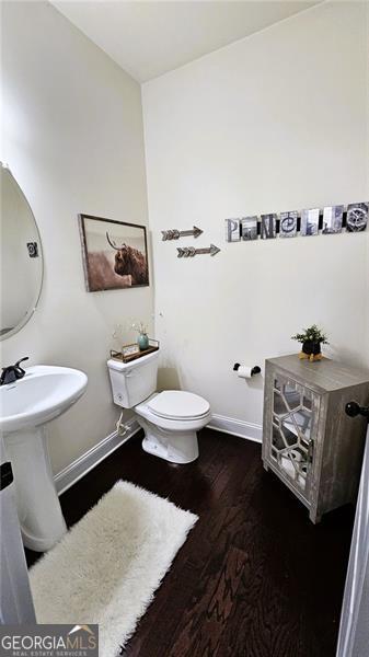 bathroom featuring hardwood / wood-style floors and toilet