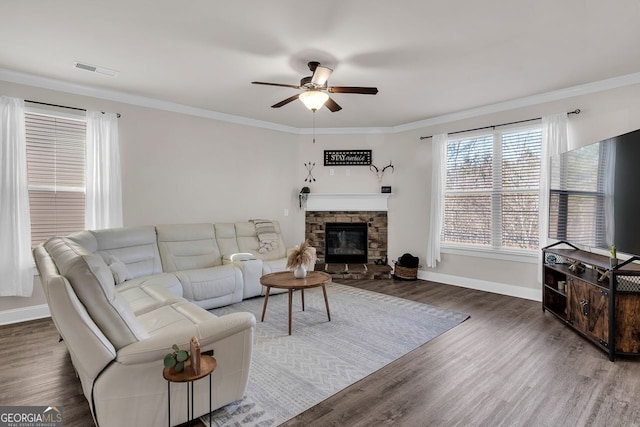 living room featuring a fireplace, dark hardwood / wood-style flooring, ceiling fan, and ornamental molding